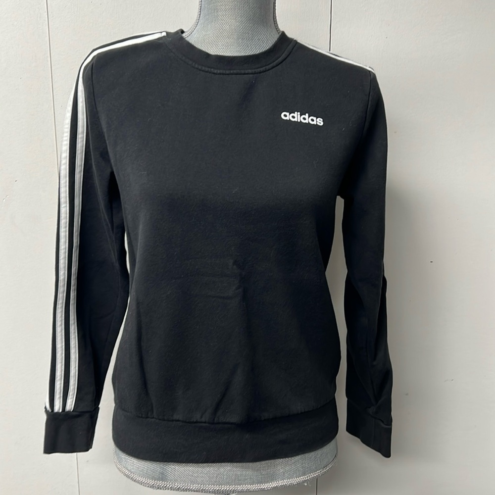 Adidas brand black sweatshirt with white striped sleeves.